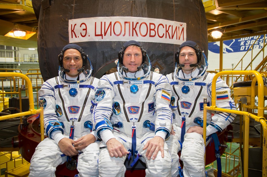 jsc2022e072270 (Sept. 7, 2022) --- At the Baikonur Cosmodrome in Kazakhstan, NASA astronaut Frank Rubio (left), Roscosmos cosmonaut Sergey Prokopyev (center) and Roscosmos cosmonaut Dmitri Petelin (right) complete training preparations in front of their Soyuz MS-22 spacecraft as they prepare for launch Sept. 21 for a six-month mission on the International Space Station. The Soyuz spacecraft bears the name of Konstantin Tsiolkovsky, the “father” of cosmonautics. Credit: NASA/Victor Zelentsov.