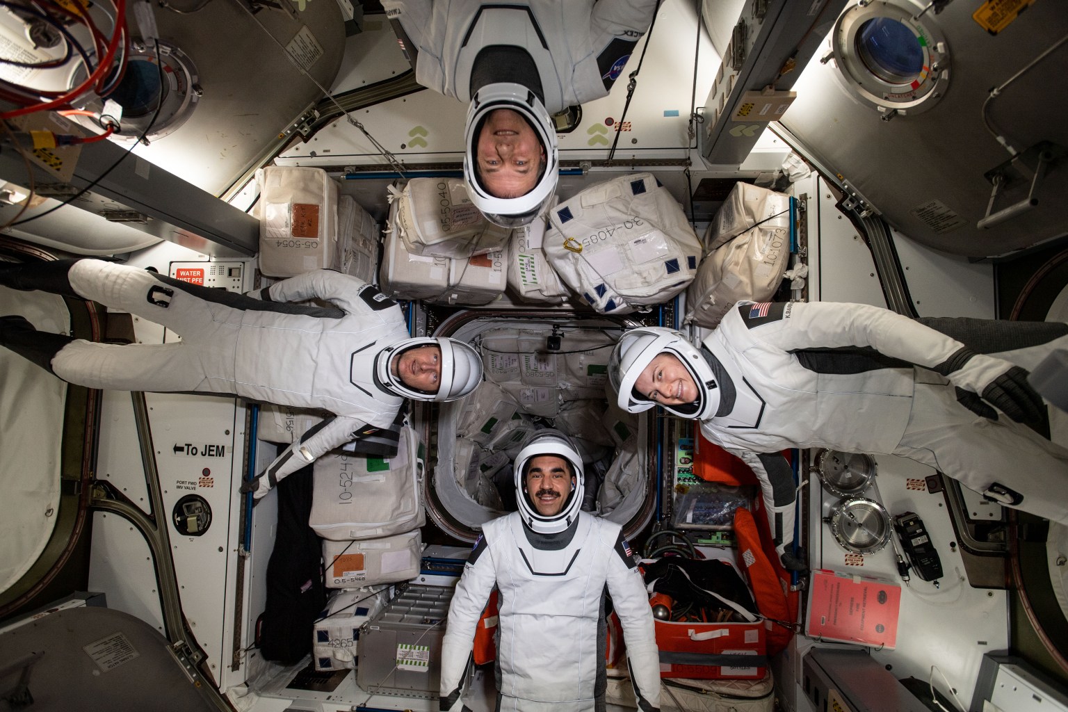 The four commercial crew astronauts representing the SpaceX Crew-3 mission are pictured in their Dragon spacesuits for a fit check aboard the International Space Station's Harmony module. Clockwise from bottom, are NASA astronaut Raja Chari; ESA (European Space Agency) astronaut Matthias Maurer; and NASA astronauts Tom Marshburn and Kayla Barron.