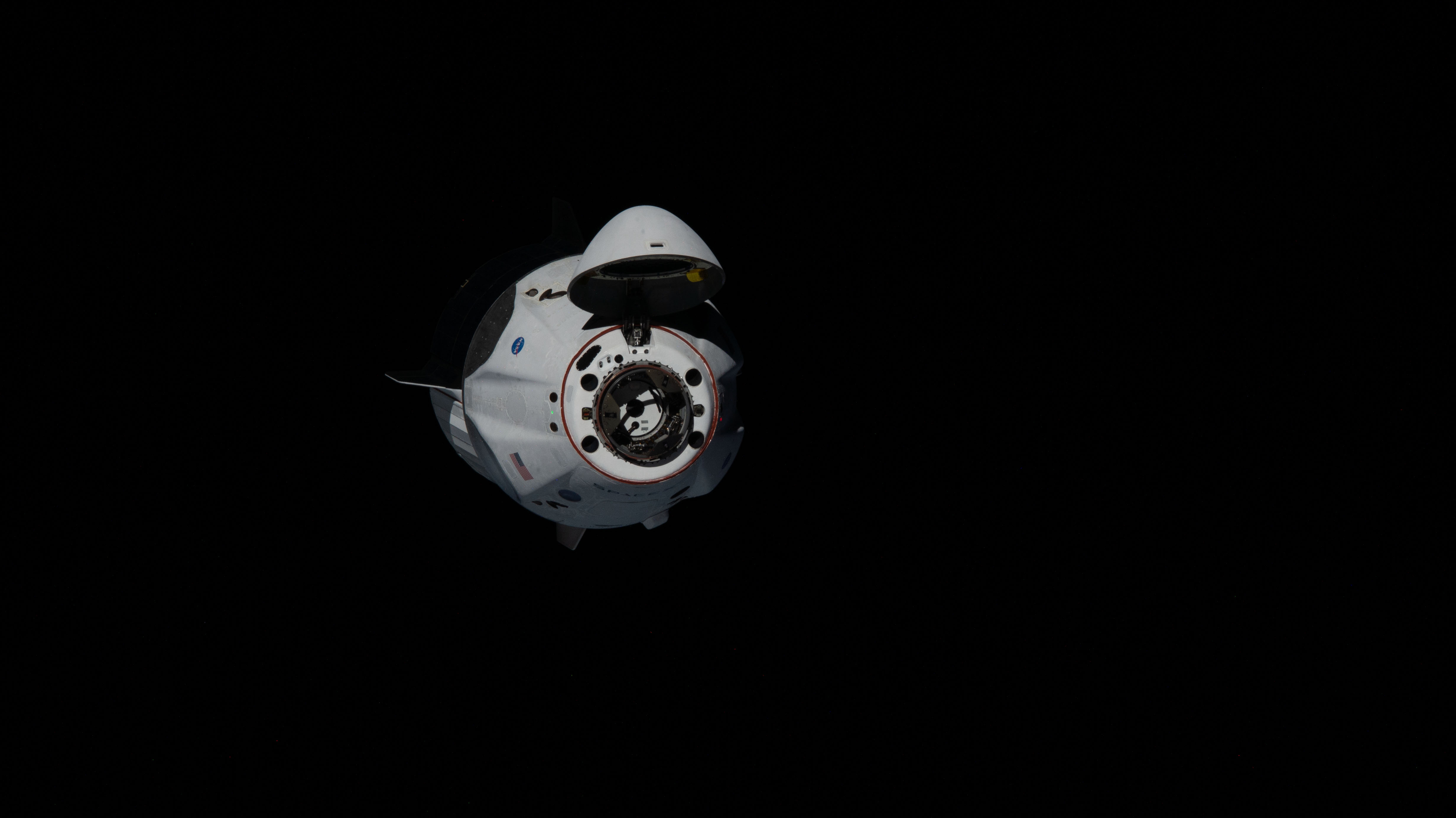 Astronauts Doug Hurley and Bob Behnken of NASA's Commercial Crew Program were aboard the SpaceX Crew Dragon as it approached the International Space Station. The Crew Dragon's nose cone is open revealing the spacecraft's docking mechanism that would connect to the Harmony module's forward International Docking Adapter.