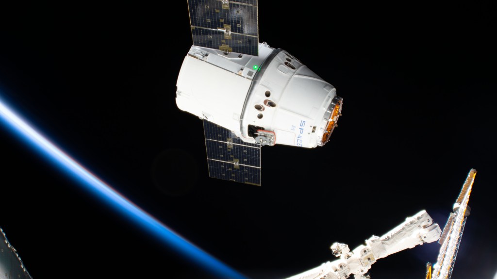 The SpaceX Dragon cargo craft approaches its capture point 10 meters from the International Space Station with the Canadarm2 robotic arm poised to reach out and grapple the resupply ship. Astronaut David Saint-Jacques would command the Canadarm2 to capture Dragon as astronaut Nick Hague backed him up and monitored systems.