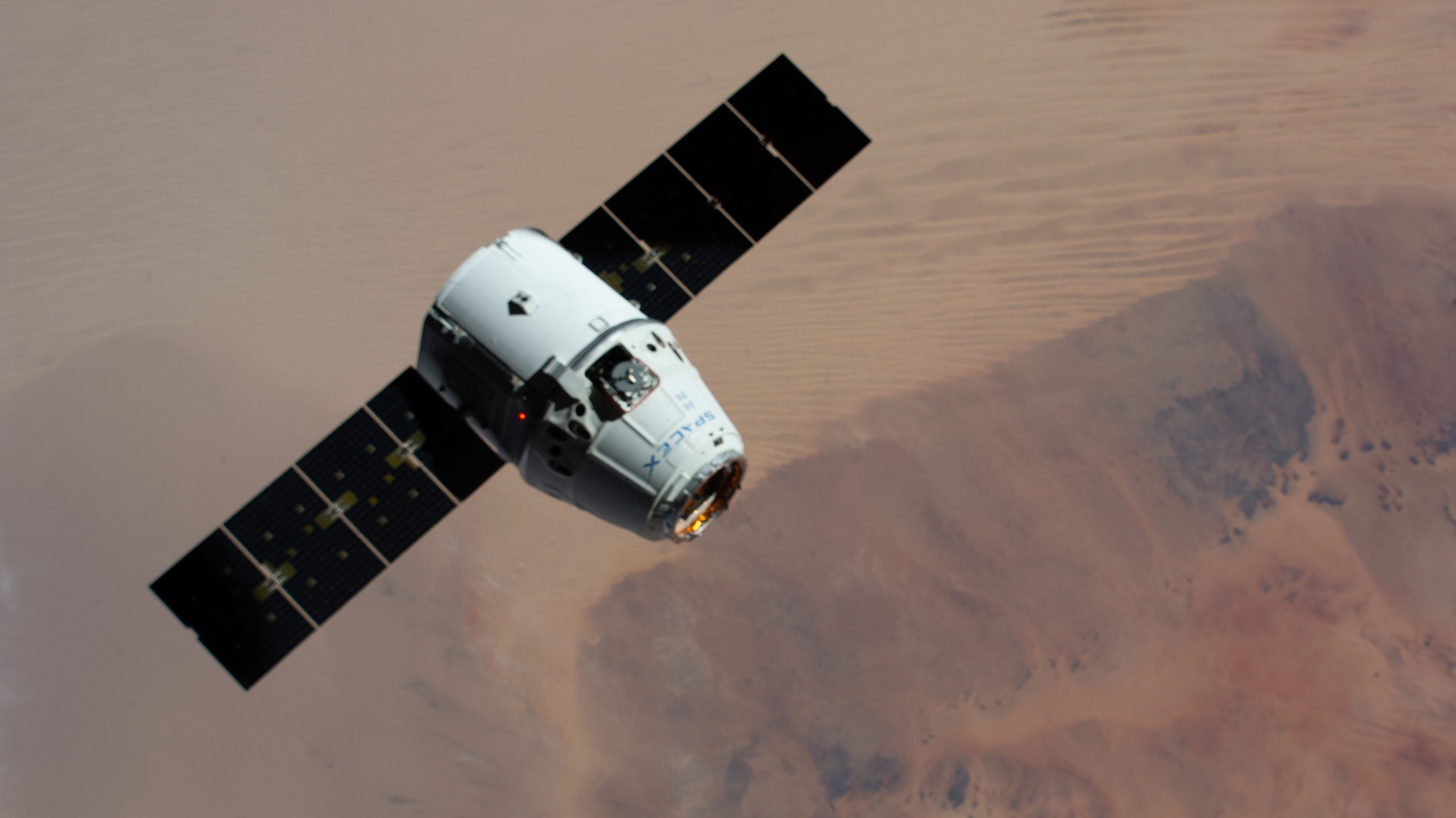 The SpaceX Dragon resupply ship approaches the International Space Station as both spacecraft orbited 257 miles above the Sahara.
