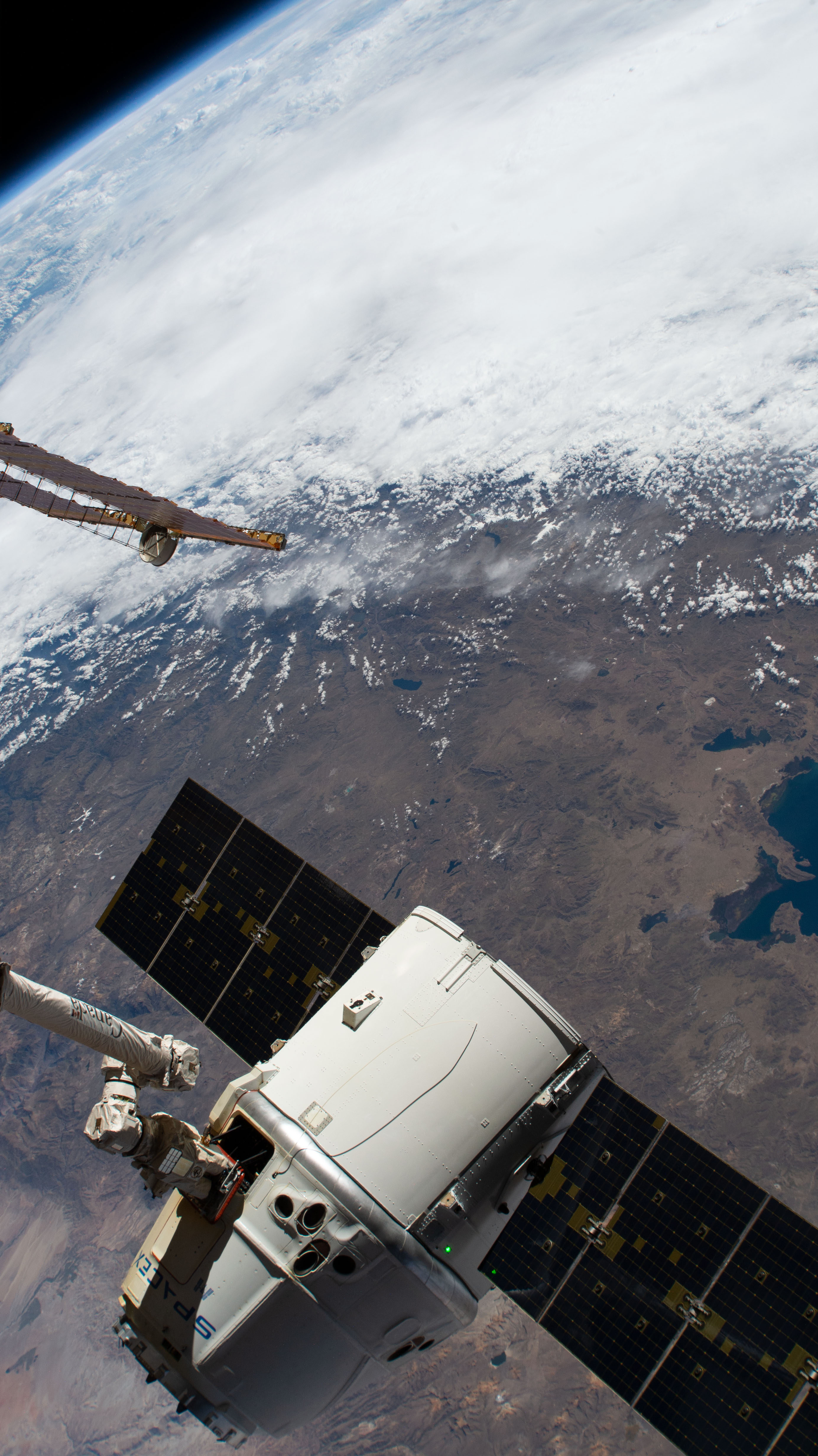The SpaceX Dragon cargo craft on its 17th contracted mission to resupply mission to the International Space Station is pictured moments before being released from the Canadarm2 robotic arm. The orbiting lab was flying 257 miles above the Pacific coast of South America.