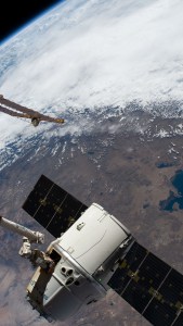 The SpaceX Dragon cargo craft on its 17th contracted mission to resupply mission to the International Space Station is pictured moments before being released from the Canadarm2 robotic arm. The orbiting lab was flying 257 miles above the Pacific coast of South America.