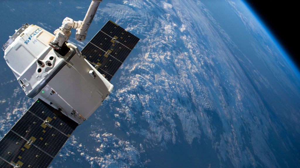 The SpaceX Dragon cargo craft on its 17th contracted mission to resupply mission to the International Space Station is pictured moments before being released from the Canadarm2 robotic arm. The orbiting lab was flying 261 miles above central Asia.