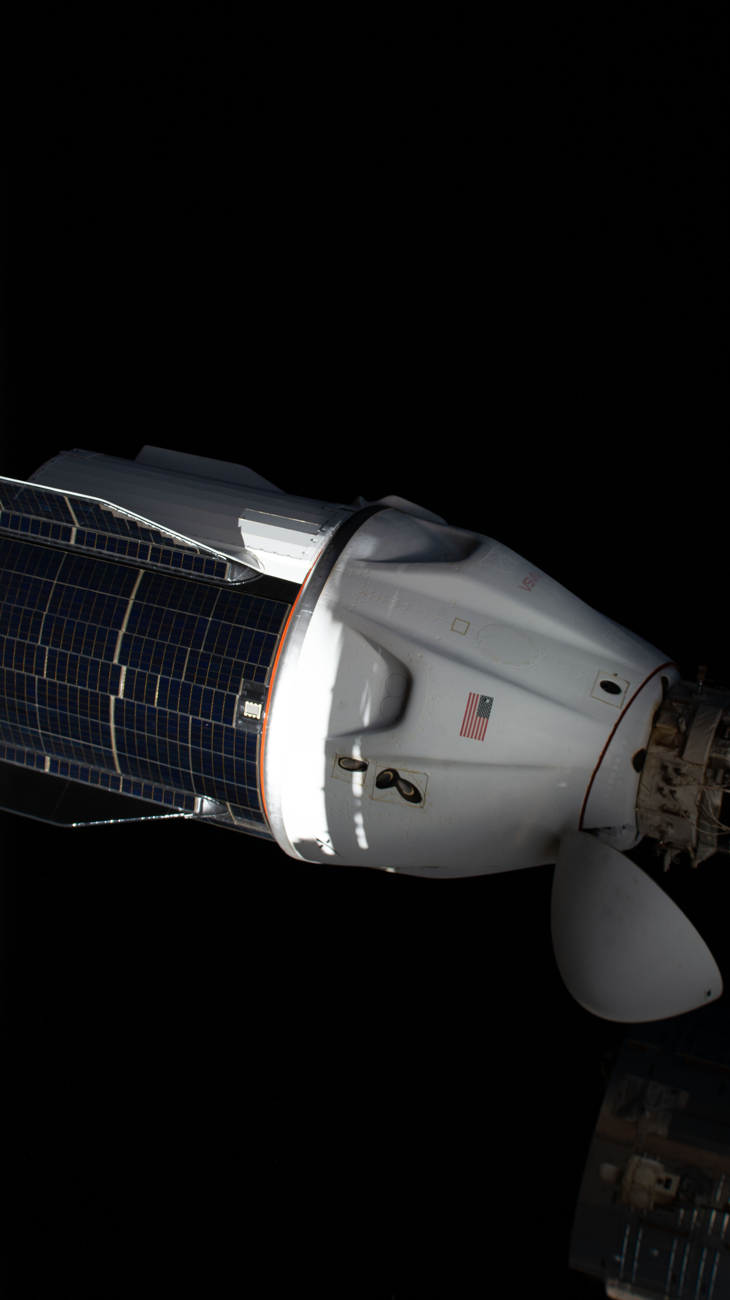 The SpaceX Dragon resupply ship, with its solar panel-covered trunk, is pictured before undocking from the Harmony module's forward port on the International Space Station.