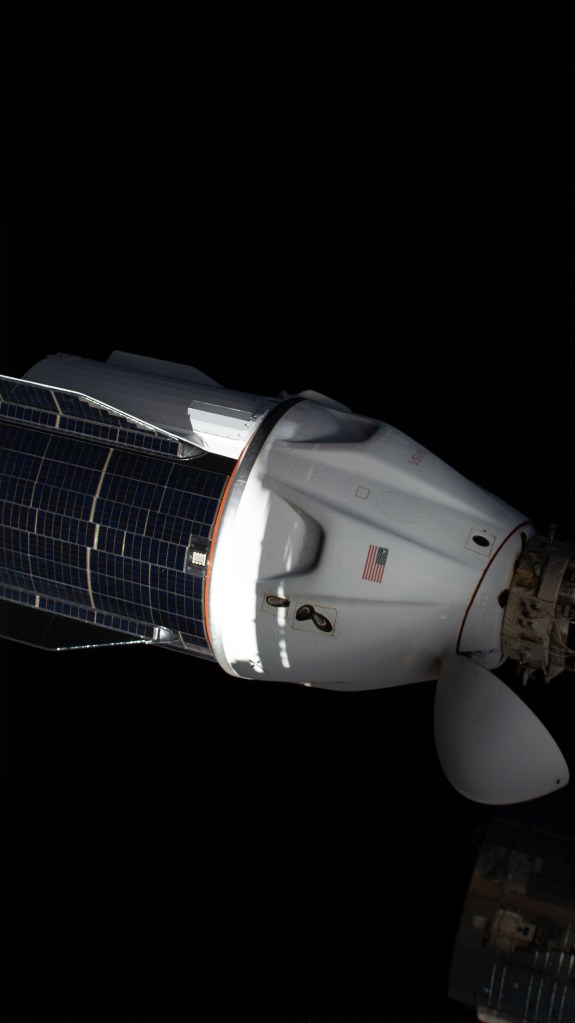The SpaceX Dragon resupply ship, with its solar panel-covered trunk, is pictured before undocking from the Harmony module's forward port on the International Space Station.