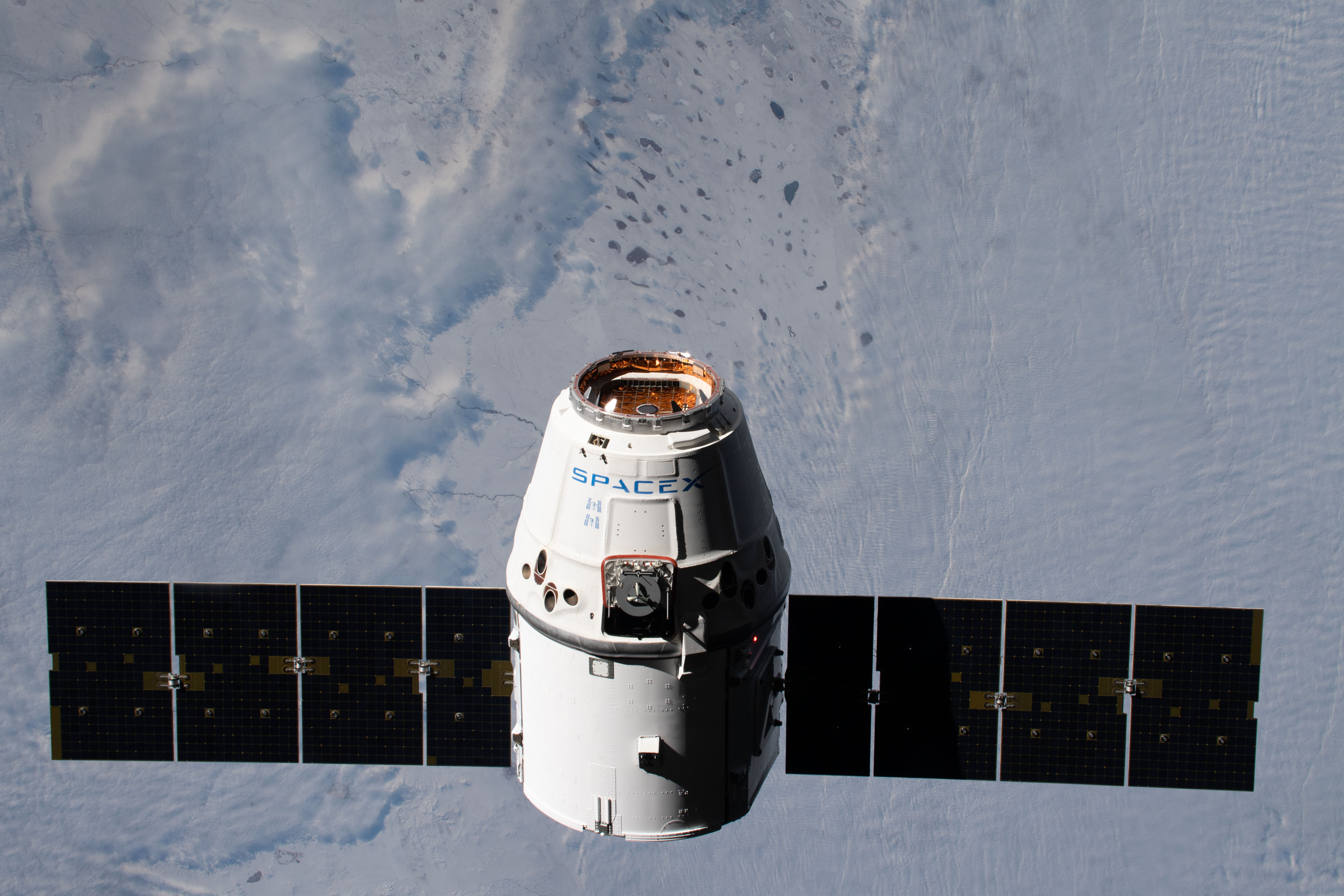 The SpaceX Dragon resupply ship approaches the International Space Station as both spacecraft were orbiting 261 miles above Kazakhstan.