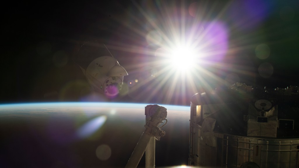 The SpaceX Dragon resupply ship, packed with over 4,000 pounds of return cargo and science experiments for analysis, backs away from the International Space Station moments after undocking from the Harmony module's forward port. The station was soaring into an orbital sunrise 260 miles above Hawaii's big island in the Pacific Ocean at the time of this photograph.
