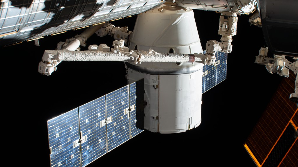 The SpaceX Dragon resupply ship is pictured in the grip of the Canadarm2 robotic arm after it was installed to the Harmony module. The International Space Station was orbiting 262 miles above the North Pacific Ocean when this photograph was taken by an external high definition camera.