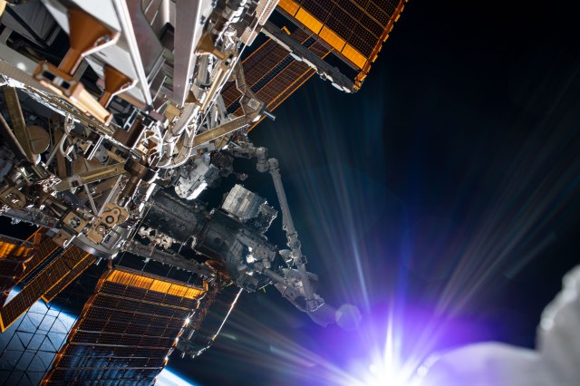 The sun beams just below the frame as NASA astronaut and Expedition 63 Commander Chris Cassidy (near center left) conducts his fourth spacewalk this year at the International Space Station. Cassidy has completed 10 spacewalks throughout his career for a total of 54 hours and 51 minutes spacewalking time.
