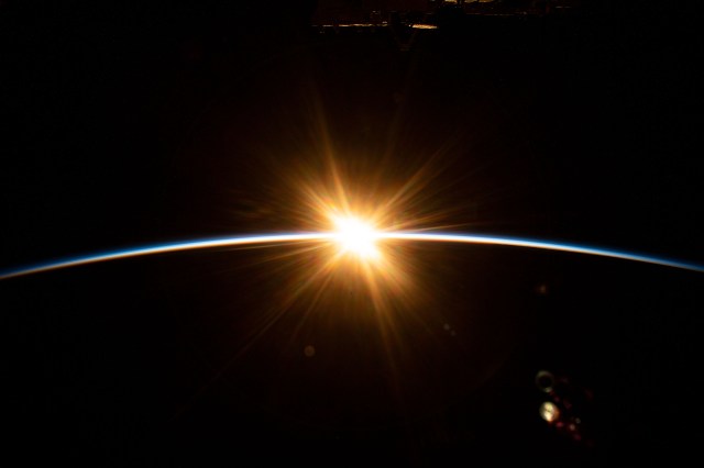 The sun's first rays burst over the Earth's horizon during an orbital sunrise as the International Space Station orbited above the Indian Ocean southwest of Australia.