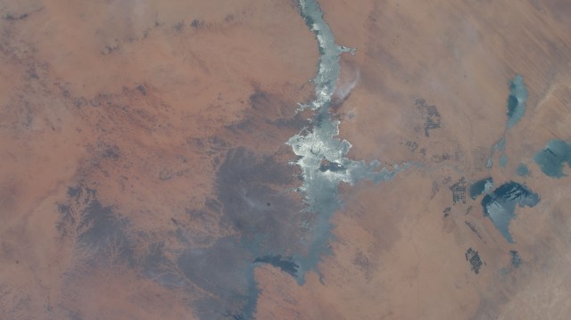 iss067e284430 (Aug. 20, 2022) --- The sun's glint beams off Egypt's Lake Nasser, one of the largest man-made lakes in the world near the border with Sudan, in this photograph from the International Space Station as it orbited 257 miles above northeastern Africa.