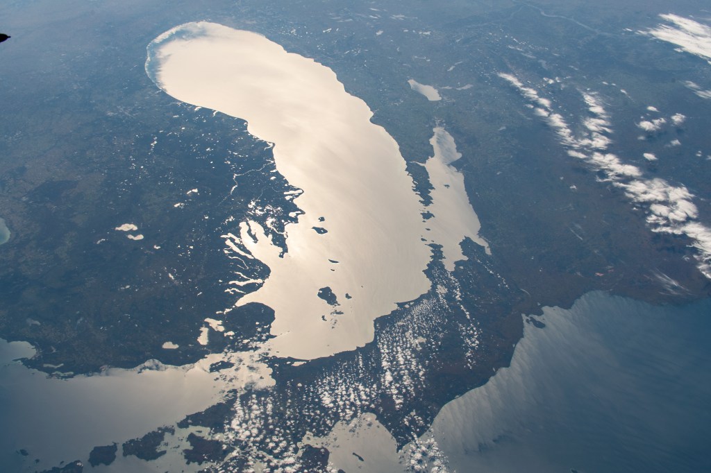 The Sun's glint beams off Lake Michigan in this southward view taken from the International Space Station orbiting 253 miles above Canada just north of Lake Superior.