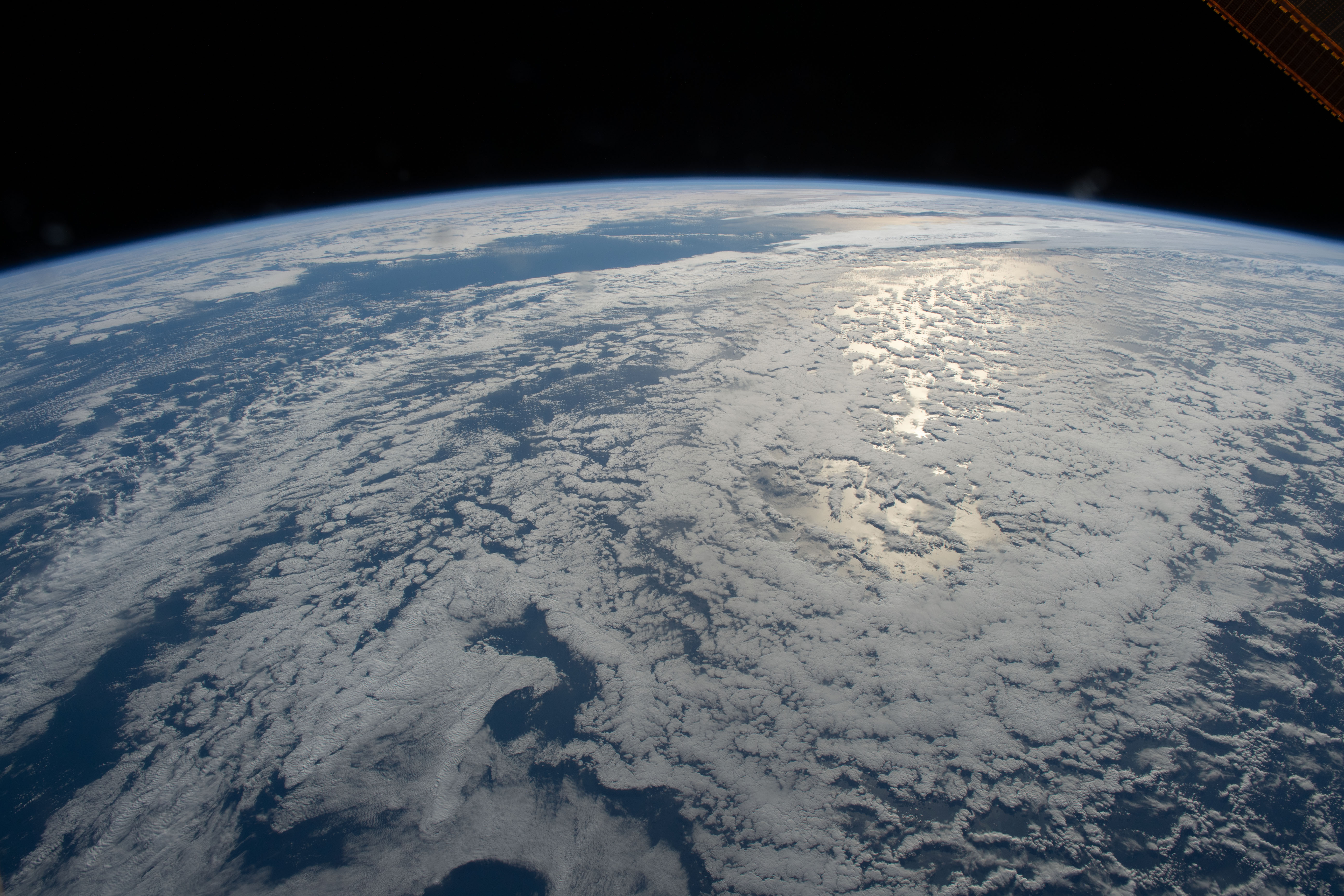 The sun's glint beams on the South Pacific Ocean as the International Space Station orbited just off the coast of Auckland, New Zealand.