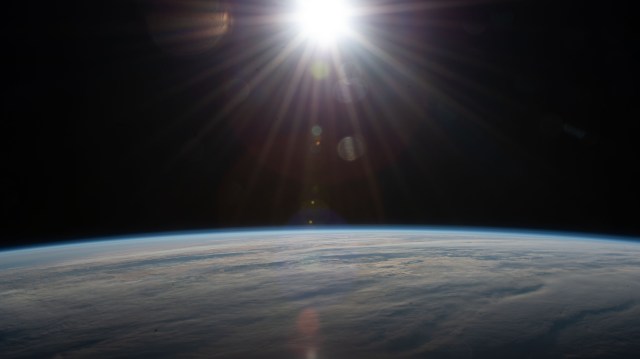 The sun's rays glisten in this photograph from an external high definition camera as the International Space Station orbited over the Atlantic Ocean southwest of South Africa.