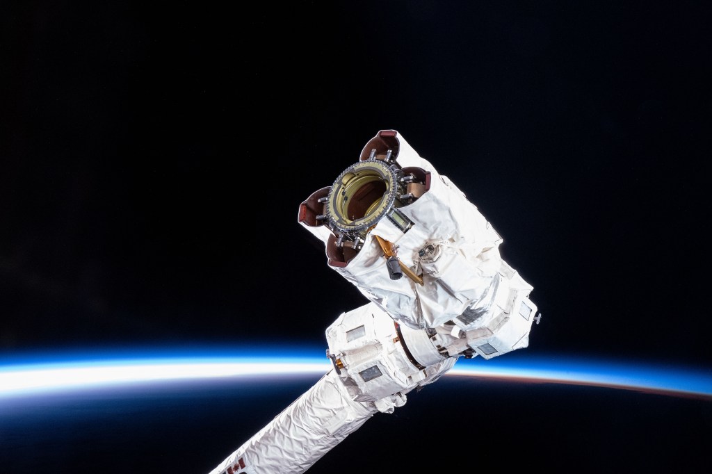 The tip of the Canadarm2 robotic arm, also called the Latching End Effector which grapples hardware, science experiments and approaching spaceships, is pictured as the International Space Station soared over the South Pacific Ocean and into an orbital sunrise.