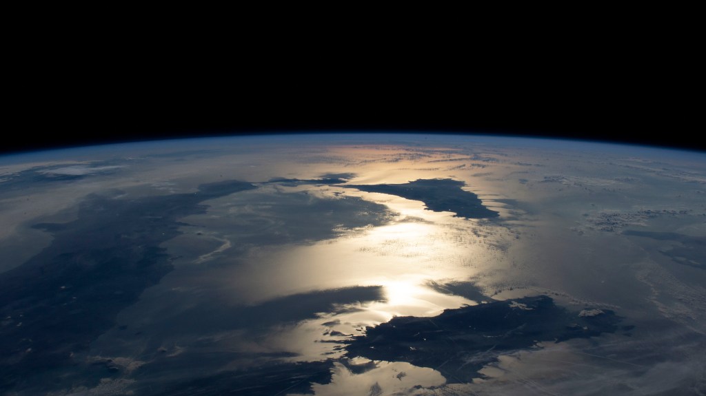 iss068e020171 (Oct. 31, 2022) --- The International Space Station was orbiting over France when an external high definition camera captured this view looking southward of the sun's glint beaming off the Tyrrhenian Sea surrounded (clockwise from left) by the coast of Italy, the Italian islands of Sicily and Sardinia, and the French island of Corsica.