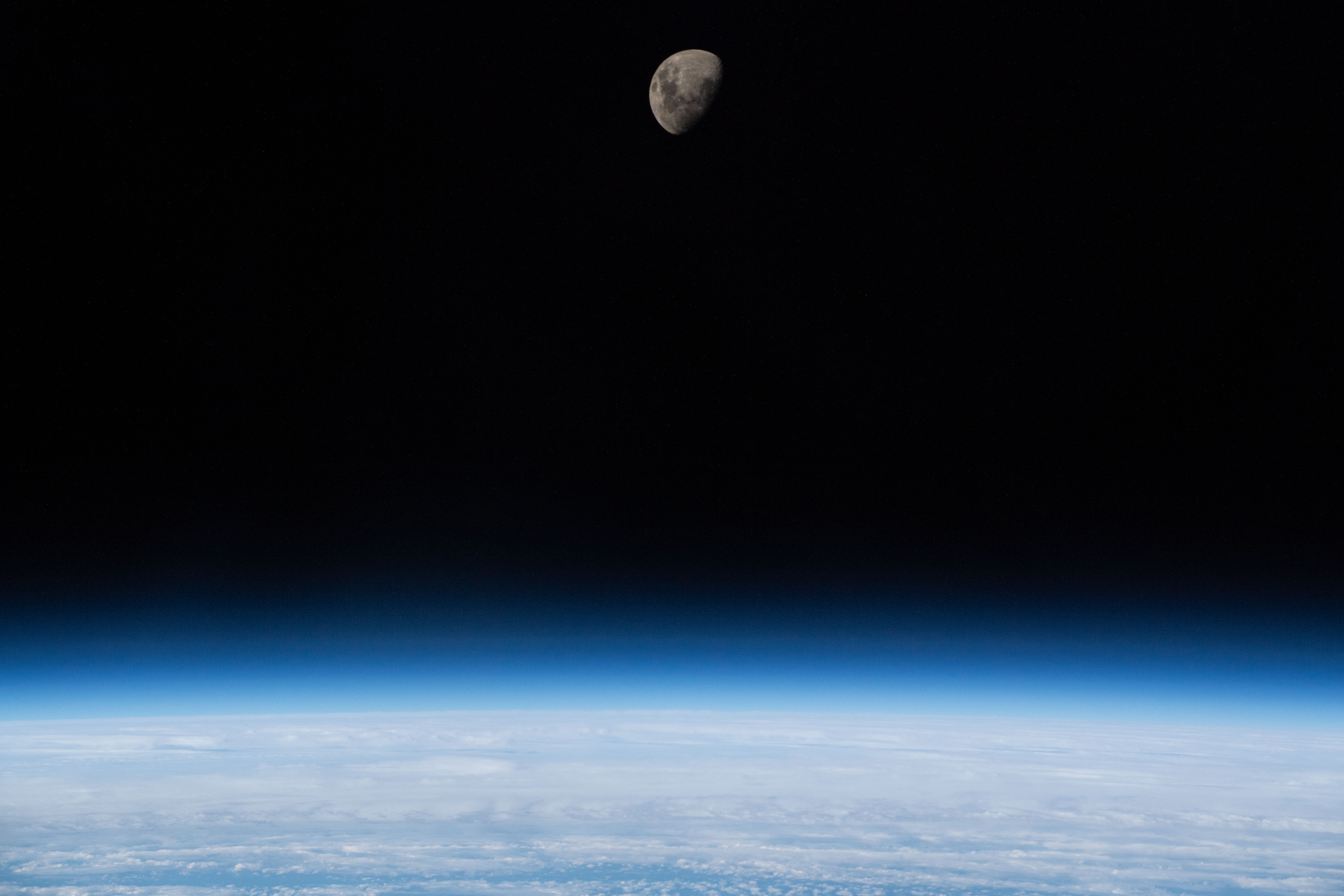 The waxing gibbous moon is pictured above Earth's limb as the International Space Station was orbiting 266 miles above the South Atlantic Ocean.