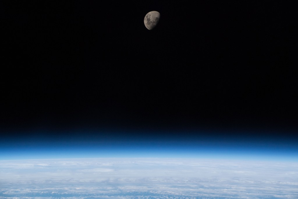 The waxing gibbous moon is pictured above Earth's limb as the International Space Station was orbiting 266 miles above the South Atlantic Ocean.