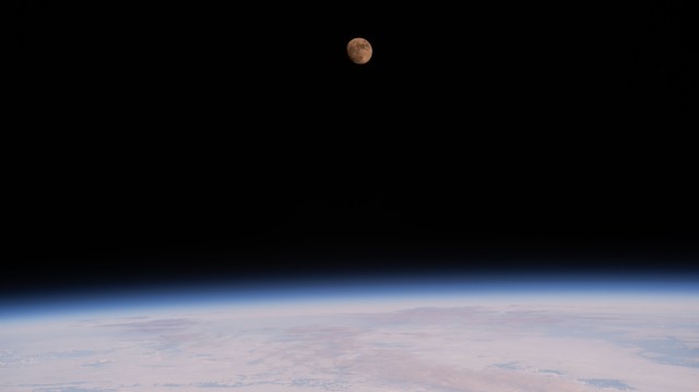 The waxing gibbous Moon is pictured above the Earth's horizon from the International Space Station as it orbited 259 miles above the northern Pacific Ocean.