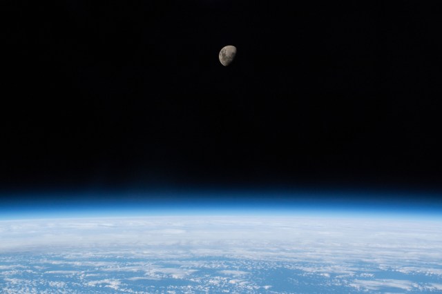 The waxing gibbous moon is pictured above Earth's limb as the International Space Station was orbiting 266 miles above the South Atlantic Ocean.