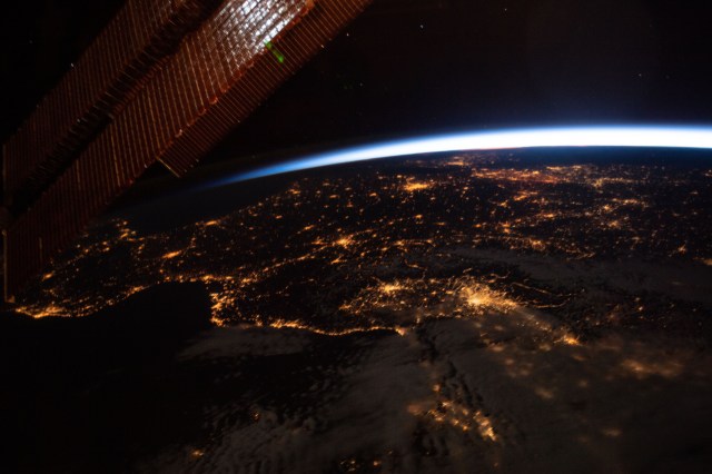 This oblique nighttime view of Western Europe and the well-lit coasts (from left) of Spain, France, and Italy was taken from the International Space Station as it orbited 256 miles above the Mediterranean Sea.