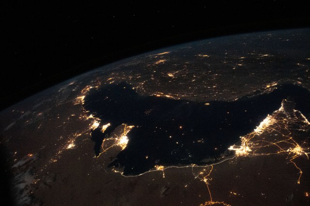 The well-lit Middle Eastern cities along the Persian Gulf coast of the Arabian Peninsula to the north of Iran were photographed from the International Space Station during an orbital night pass.