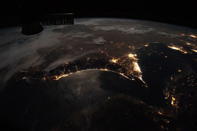 Photographed from the International Space Station at night, the well-lit United Arab Emirates (center right) is situated at the northeast end of the Arabian Peninsula in the southern Persian Gulf, with Qatar and Bahrain (far right) to the north.