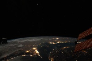 Photographed from the International Space Station at night, the well-lit United Arab Emirates (lower center) is situated at the northeast end of the Arabian Peninsula, with Qatar and Bahrain to the north on the coast of the Persian Gulf.