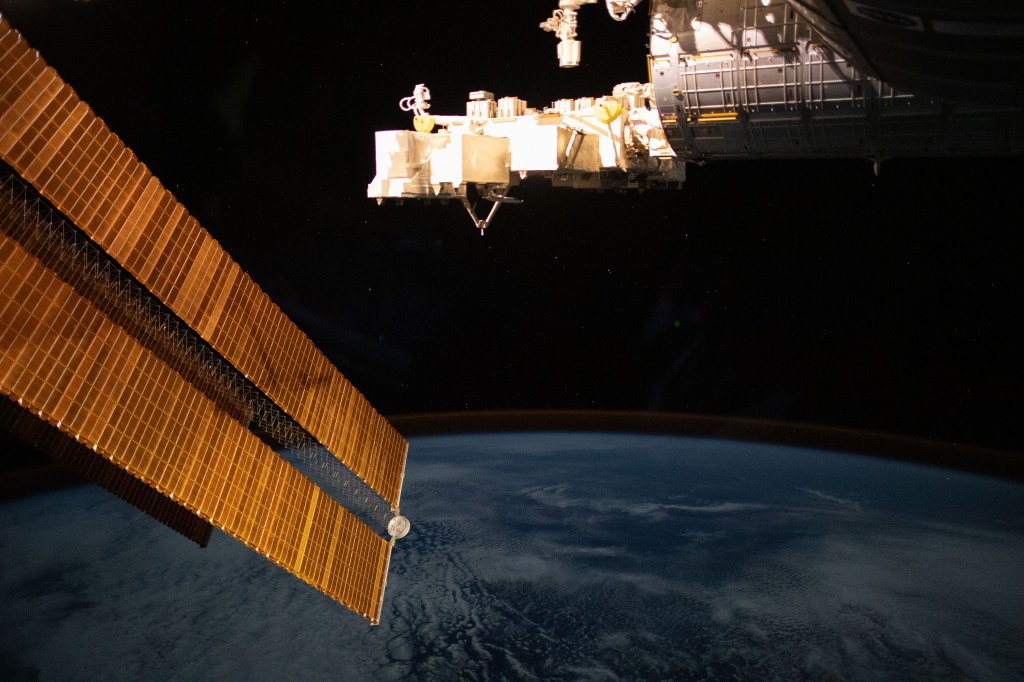 The wispy atmospheric layer of the air glow crowns the Earth's horizon in this nighttime photograph from the International Space Station as it orbited over the South Atlantic Ocean. In the foreground, are a pair of the station's main solar arrays (left) and the Kibo laboratory module's Exposed Facility (top center) from JAXA (Japan Aerospace Exploration Agency).