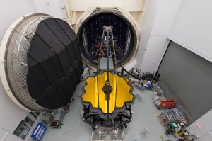 NASA's James Webb Space Telescope is pictured sitting in front of the 40-foot door to Chamber A before entering to undergo tests at sub-freezing cryogenic temperatures. Credits: NASA/Desiree Stover