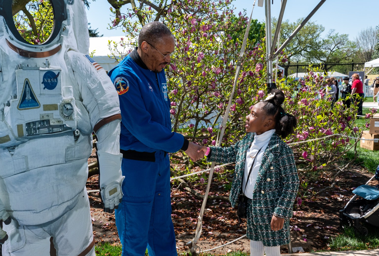 NASA astronaut Alvin Drew shakes a hands with a guest during the White House Easter Egg Roll, Monday, April 10, 2023, on the South Lawn of the White House in Washington.