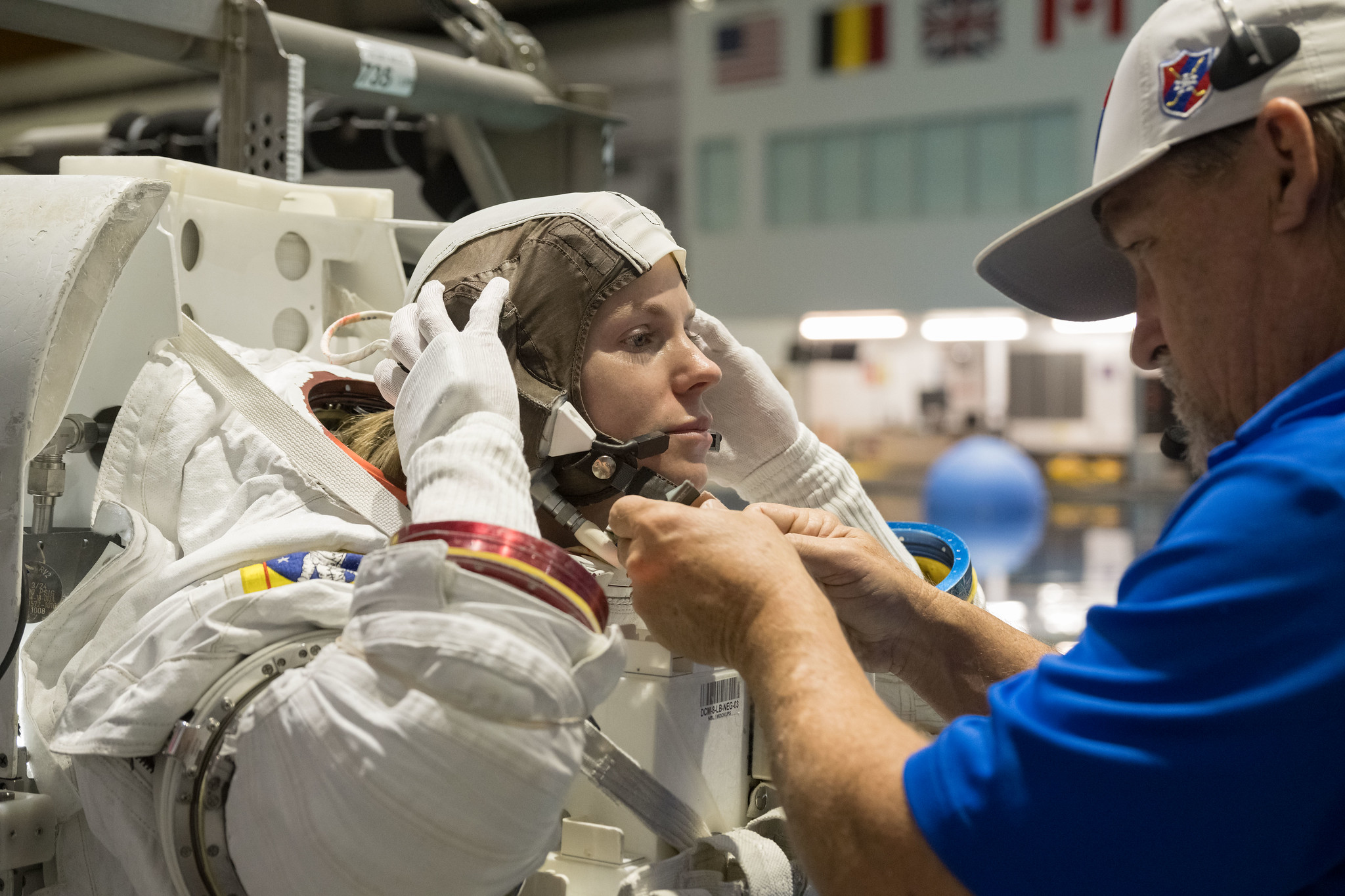 NASA astronaut Zena Cardman, assisted by a technician, trains for a spacewalk at the Neutral Buoyancy Laboratory at NASA's Johnson Space Center in Houston, Texas, for the SpaceX Crew-9 mission to the International Space Station.