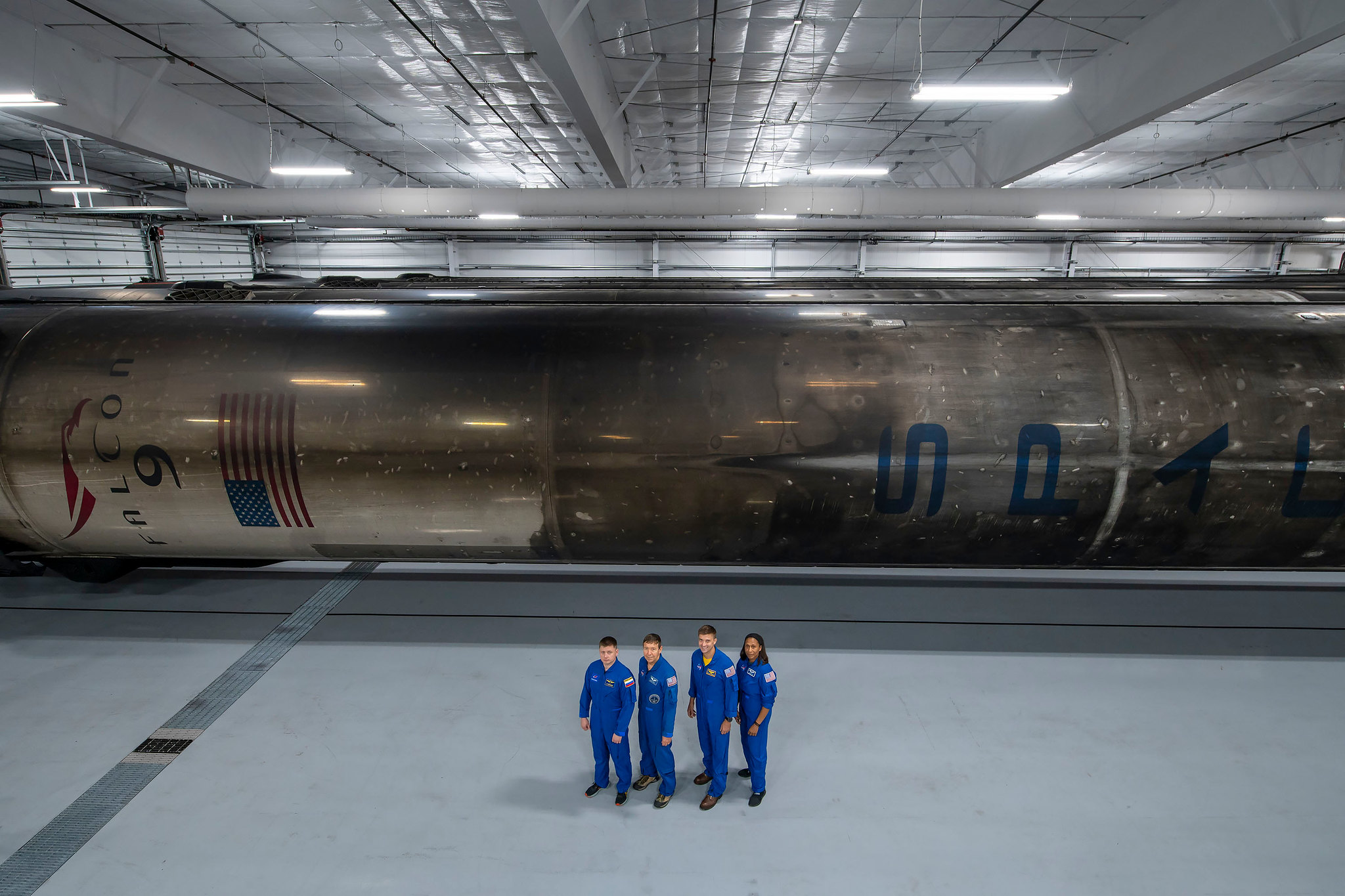 The four crew members that comprise the SpaceX Crew-8 mission pose for a photo inside SpaceX Hangar X at the Kennedy Space Center in Florida.