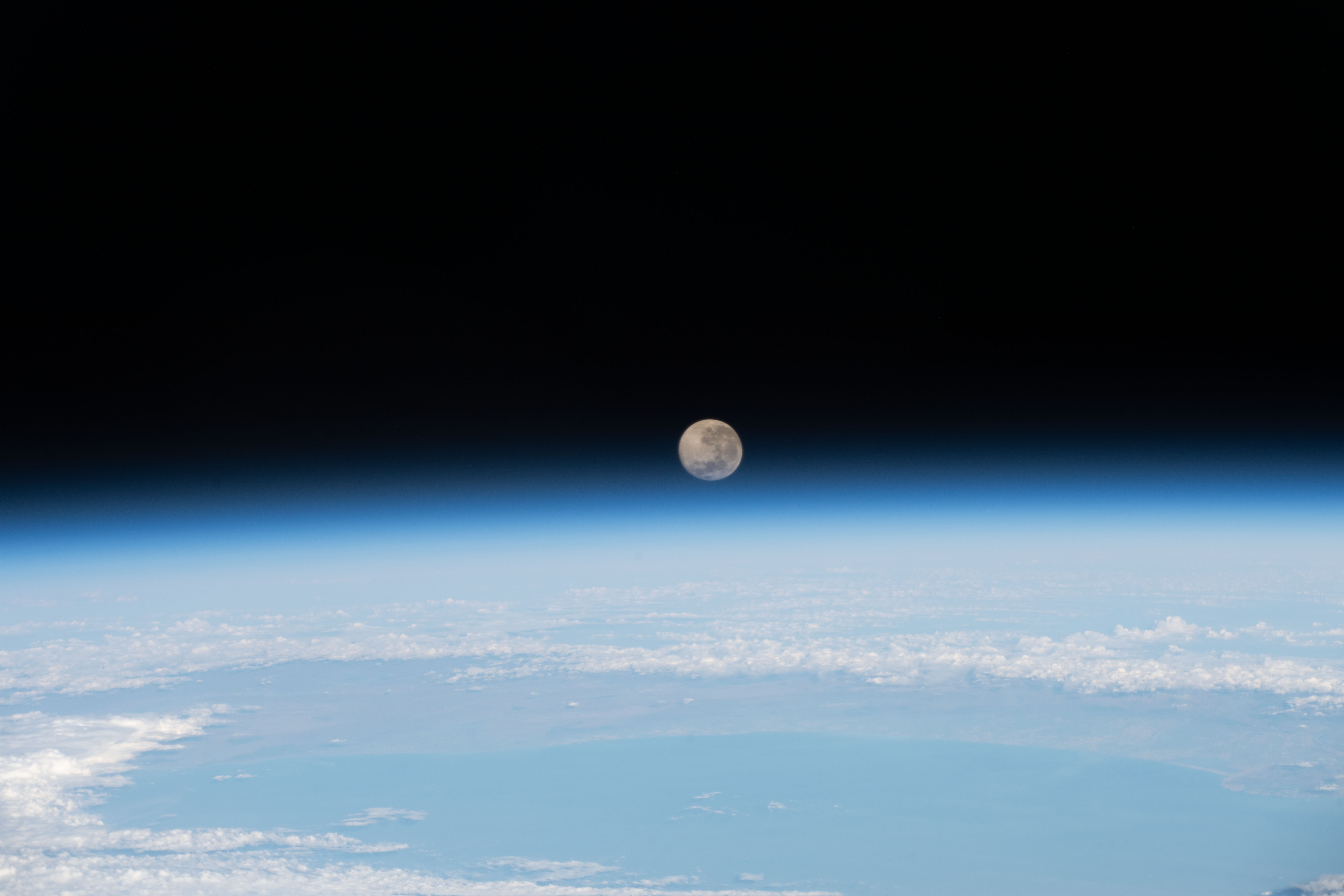 iss070e089927 (Jan. 26, 2024) -- January's full Moon rises just above the blue glow of Earth's horizon as the International Space Station orbited 271 miles over the South Pacific Ocean.