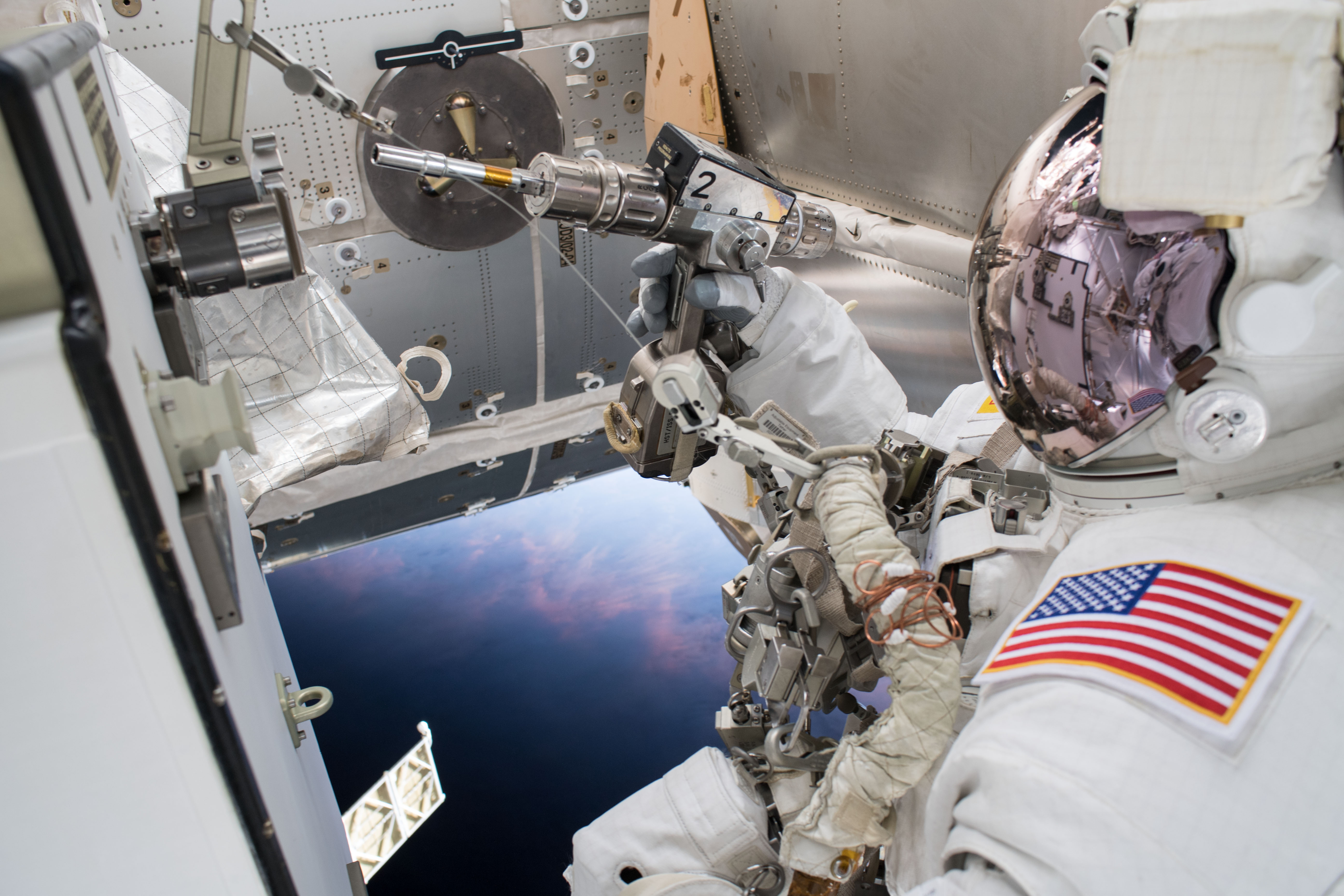 Astronaut Drew Feustel is pictured outside of the International Space Station during a spacewalk on May 16 to swap thermal control gear.