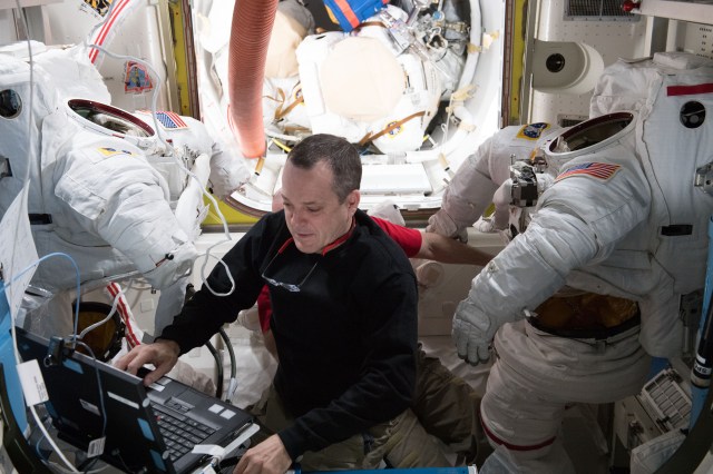 Astronaut Ricky Arnold completes the scrubbing of water cooling loops inside a pair of U.S. spacesuits after the completion of spacewalk on March 29, 2018.