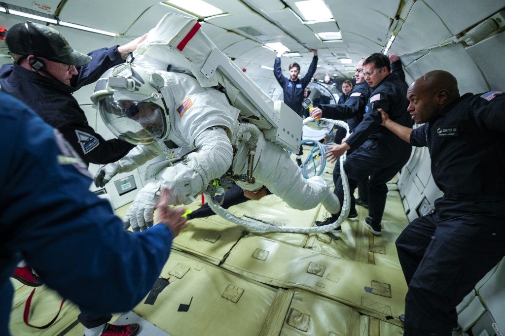 Collins Aerospace’s chief test astronaut John “Danny” Olivas demonstrates a series of tasks during testing of Collins’ next-generation spacesuit while aboard a zero-gravity aircraft.