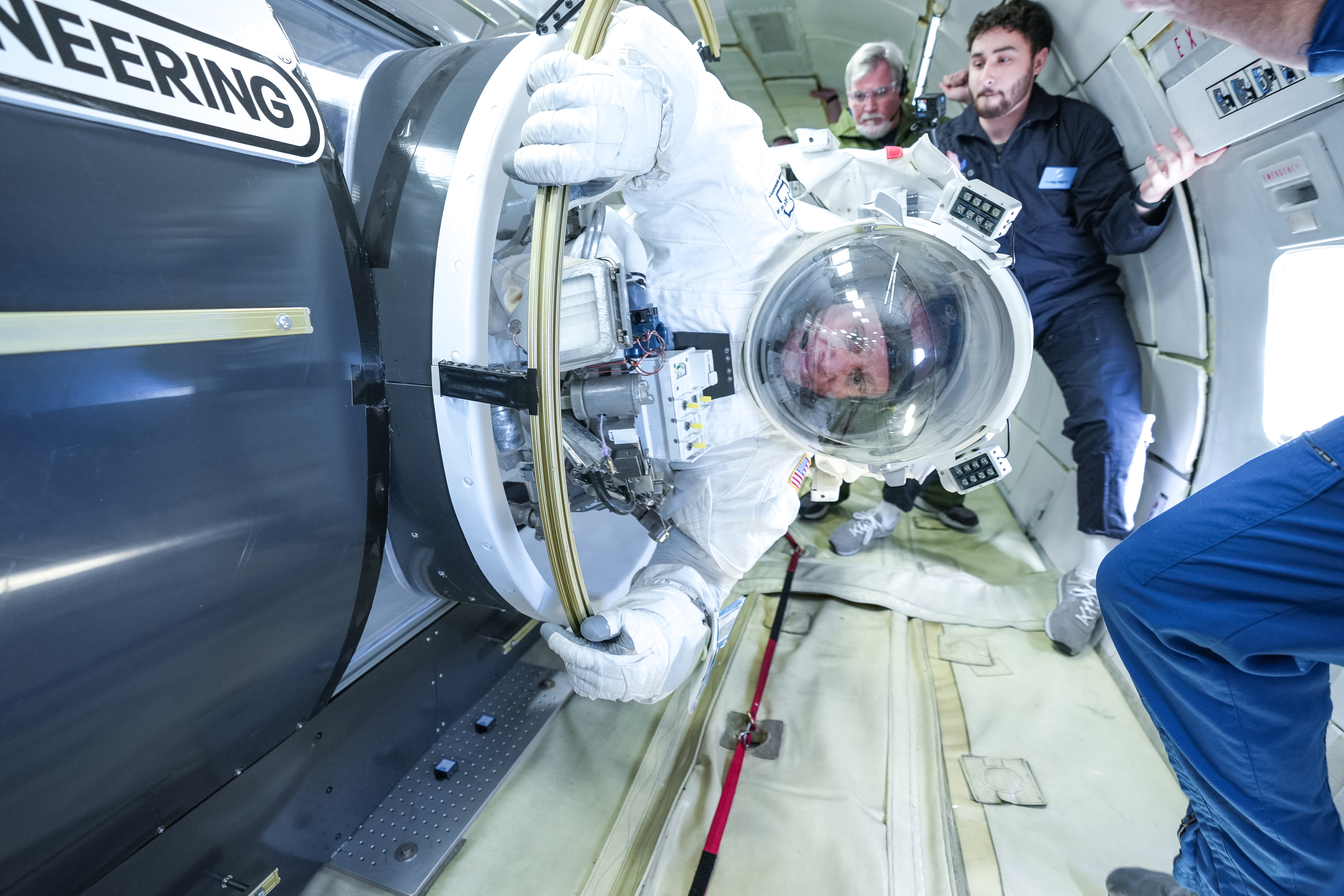 Collins Aerospace’s chief test astronaut John “Danny” Olivas demonstrates a series of tasks during testing of Collins’ next-generation spacesuit while aboard a zero-gravity aircraft.