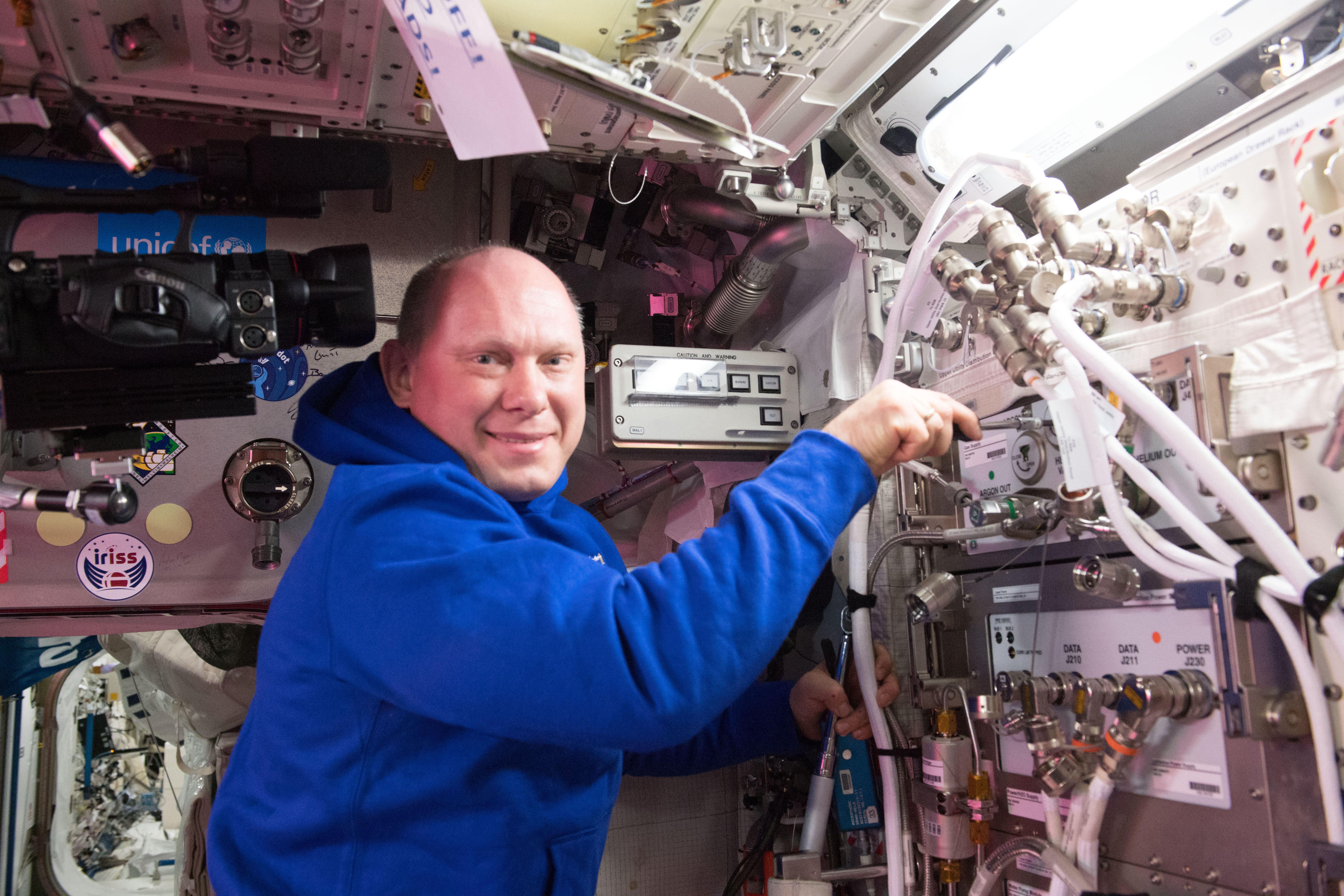 Cosmonaut Oleg Artemyev works on space station hardware at the end of his workday.