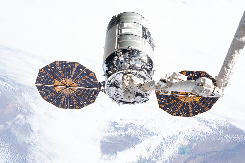 iss062e025579 (Feb. 18, 2020) --- Northrop Grumman's Cygnus cargo craft is pictured in the grips of the Canadarm2 robotic arm shortly after being captured completing a two-and-half-day trip that began with a launch from NASA's Wallops Flight Facility in Virginia.