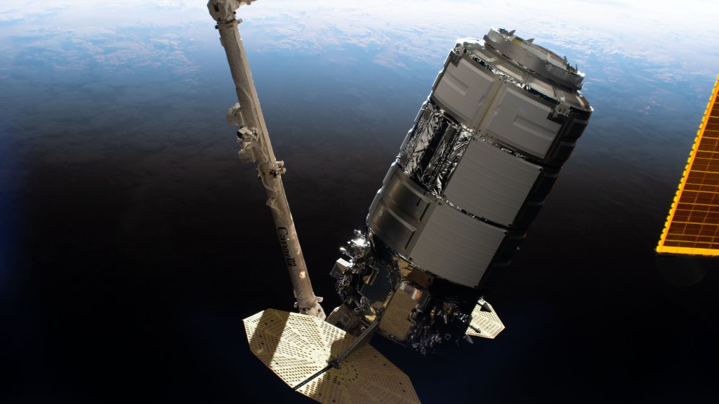iss062e025684 (Feb. 18, 2020) --- Northrop Grumman's Cygnus cargo craft is pictured in the grips of the Canadarm2 robotic arm shortly after being captured and being maneuvered toward the Unity module where it will stay for three months.