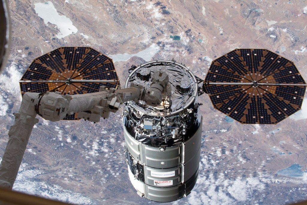 iss062e024022 (Feb. 18, 2020) --- Northrop Grumman's Cygnus cargo craft is pictured in the grips of the Canadarm2 robotic arm shortly after being captured completing a two-and-half-day trip that began with a launch from NASA's Wallops Flight Facility in Virginia.