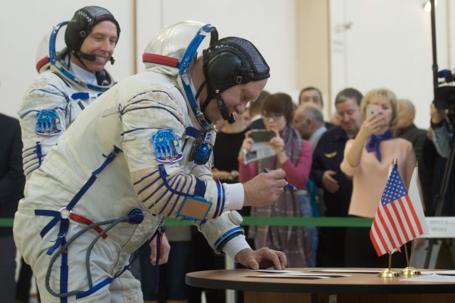 At the Gagarin Cosmonaut Training Center in Star City, Russia, Expedition 55 crew member Oleg Artemyev of Roscosmos signs in for a final day of qualification exams Feb. 21 as crewmate Drew Feustel of NASA looks on. Artemyev, Feustel and Ricky Arnold of NASA will launch March 21 from the Baikonur Cosmodrome in Kazakhstan on the Soyuz MS-08 spacecraft for a five-month mission on the International Space Station.