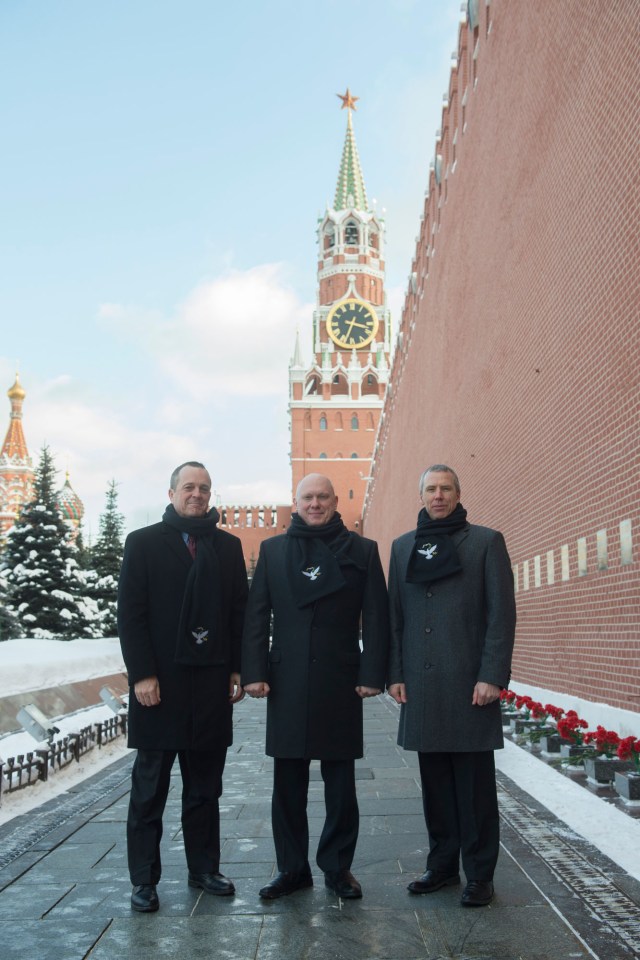 At Red Square in Moscow, Expedition 55 crew members Ricky Arnold of NASA (left), Oleg Artemyev of Roscosmos (center) and Drew Feustel of NASA (right) pose for pictures by the Kremlin Wall Feb. 22 in traditional pre-launch activities. They will launch March 21 on the Soyuz MS-08 spacecraft from the Baikonur Cosmodrome in Kazakhstan for a five-month mission on the International Space Station.
