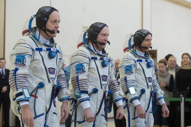 At the Gagarin Cosmonaut Training Center in Star City, Russia, Expedition 55 crew members Ricky Arnold of NASA (left), Oleg Artemyev of Roscosmos (center) and Drew Feustel of NASA (right) report to officials Feb. 21 for the final day of crew qualification exams. They will launch March 21 from the Baikonur Cosmodrome in Kazakhstan on the Soyuz MS-08 spacecraft for a five-month mission on the International Space Station.