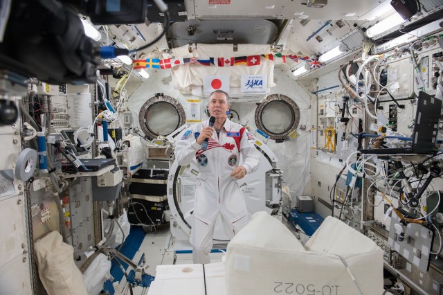 Expedition 55 Flight Engineer Drew Feustel of NASA is inside the Japanese Kibo laboratory module talking to dignitaries on Earth, including university officials, musicians and scientists, during an educational event that took place at Queen's University in Kingston, Ontario.