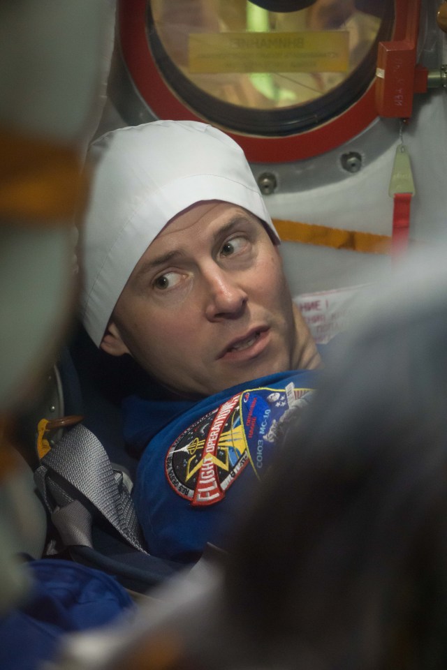 At the Baikonur Cosmodrome in Kazakhstan, Expedition 57 crew member Nick Hague is seen through a window on the Soyuz MS-10 spacecraft as he conducted a fit check dress rehearsal Sept. 26. Hague and Alexey Ovchinin of Roscosmos will launch Oct. 11 in the Soyuz MS-10 from the Baikonur Cosmodrome for a six-month mission on the International Space Station.
