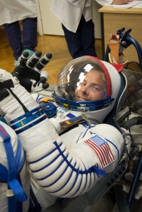 At the Baikonur Cosmodrome in Kazakhstan, Expedition 57 crew member Nick Hague of NASA flashes a smile in his Russian Sokol launch and entry suit Sept. 26 during a pressure and leak check as part of pre-launch training activities. Hague and Alexey Ovchinin of Roscosmos will launch Oct. 11 in the Soyuz MS-10 spacecraft from the Baikonur Cosmodrome for a six-month mission on the International Space Station.