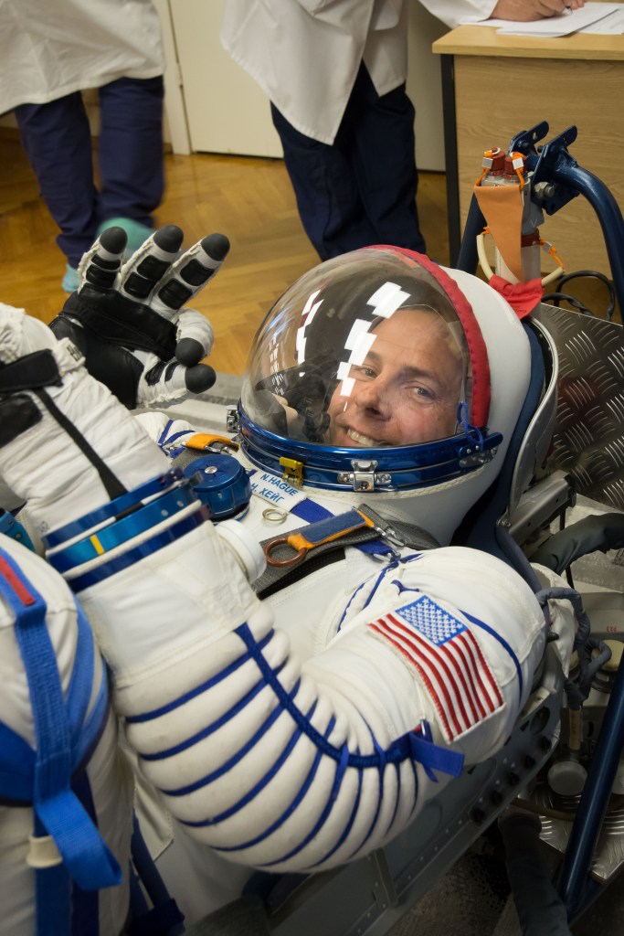 At the Baikonur Cosmodrome in Kazakhstan, Expedition 57 crew member Nick Hague of NASA flashes a smile in his Russian Sokol launch and entry suit Sept. 26 during a pressure and leak check as part of pre-launch training activities. Hague and Alexey Ovchinin of Roscosmos will launch Oct. 11 in the Soyuz MS-10 spacecraft from the Baikonur Cosmodrome for a six-month mission on the International Space Station.